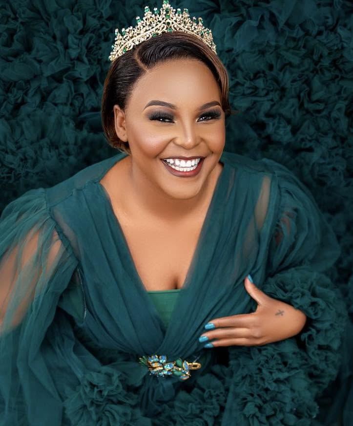 Maclean Sandra Phiri wearing a crown and emerald gown