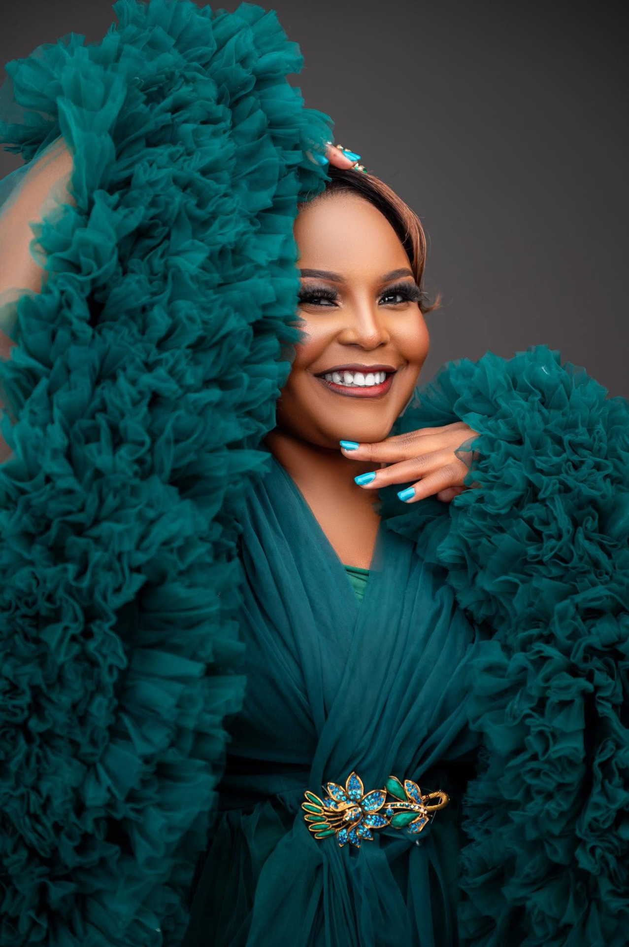 Portrait of Maclean Sandra Phiri in an emerald ruffled gown