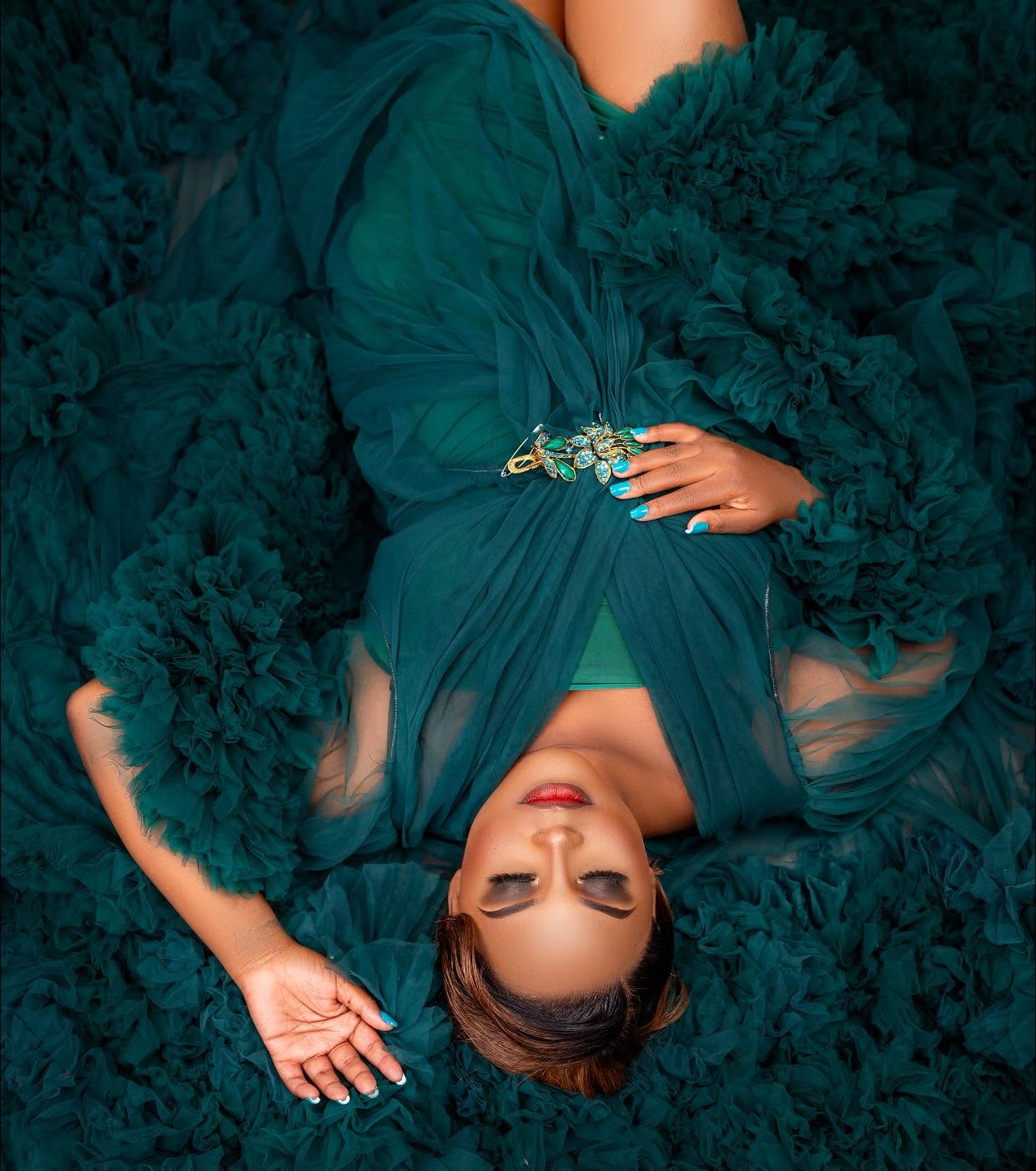 Portrait of Maclean Sandra Phiri resting on emerald tulle